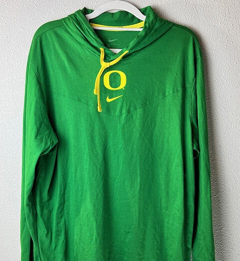 Full view of Oregon Ducks lightweight hoodie in green with Nike branding.