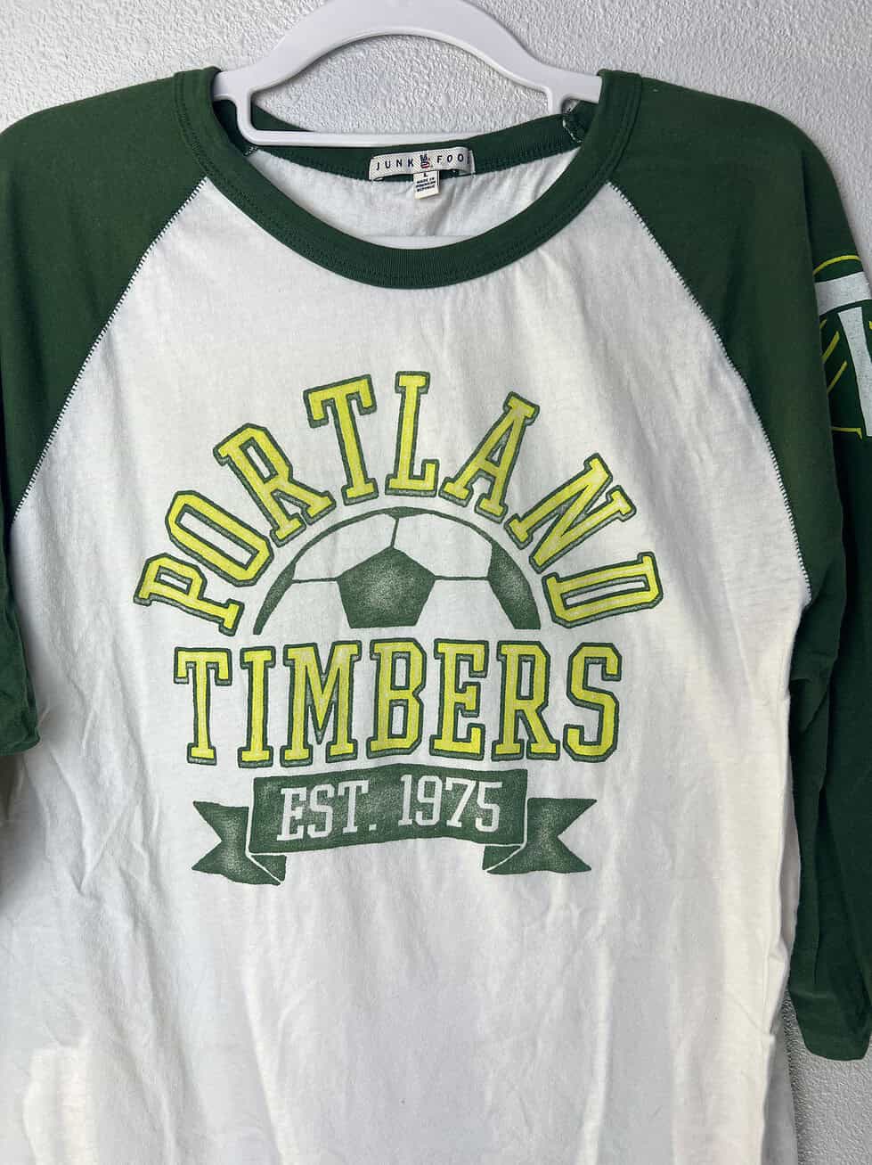 Close-up of Junk Food label on Portland Timbers graphic tee.
