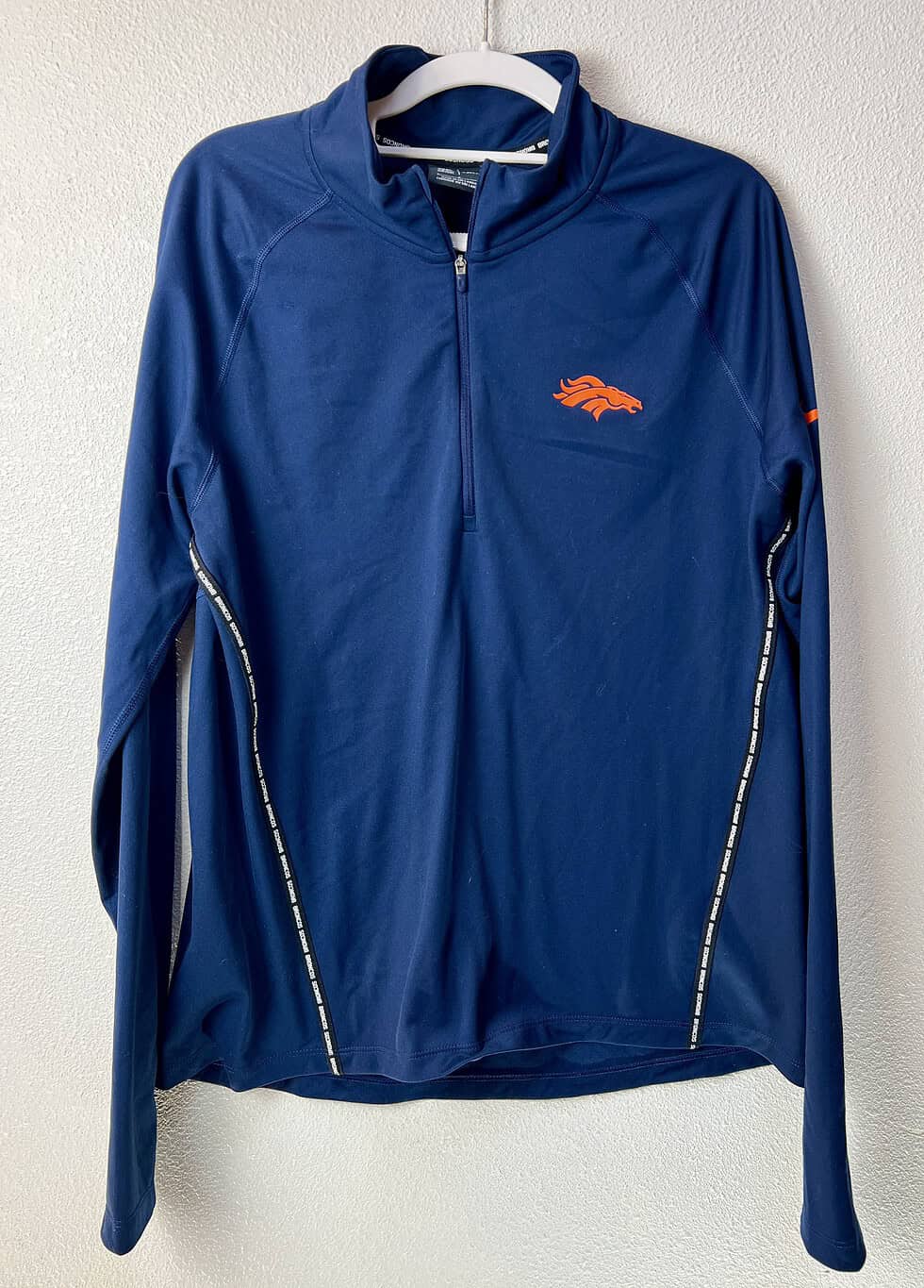 Front view of Nike Dri-FIT Denver Broncos 1/4 zip pullover in navy blue.