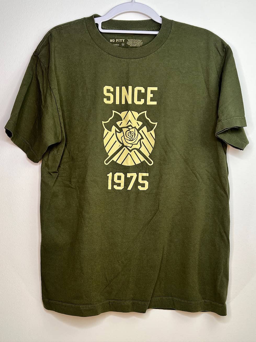 Front of No Pity Original “Since 1975" green t-shirt with Timbers crest