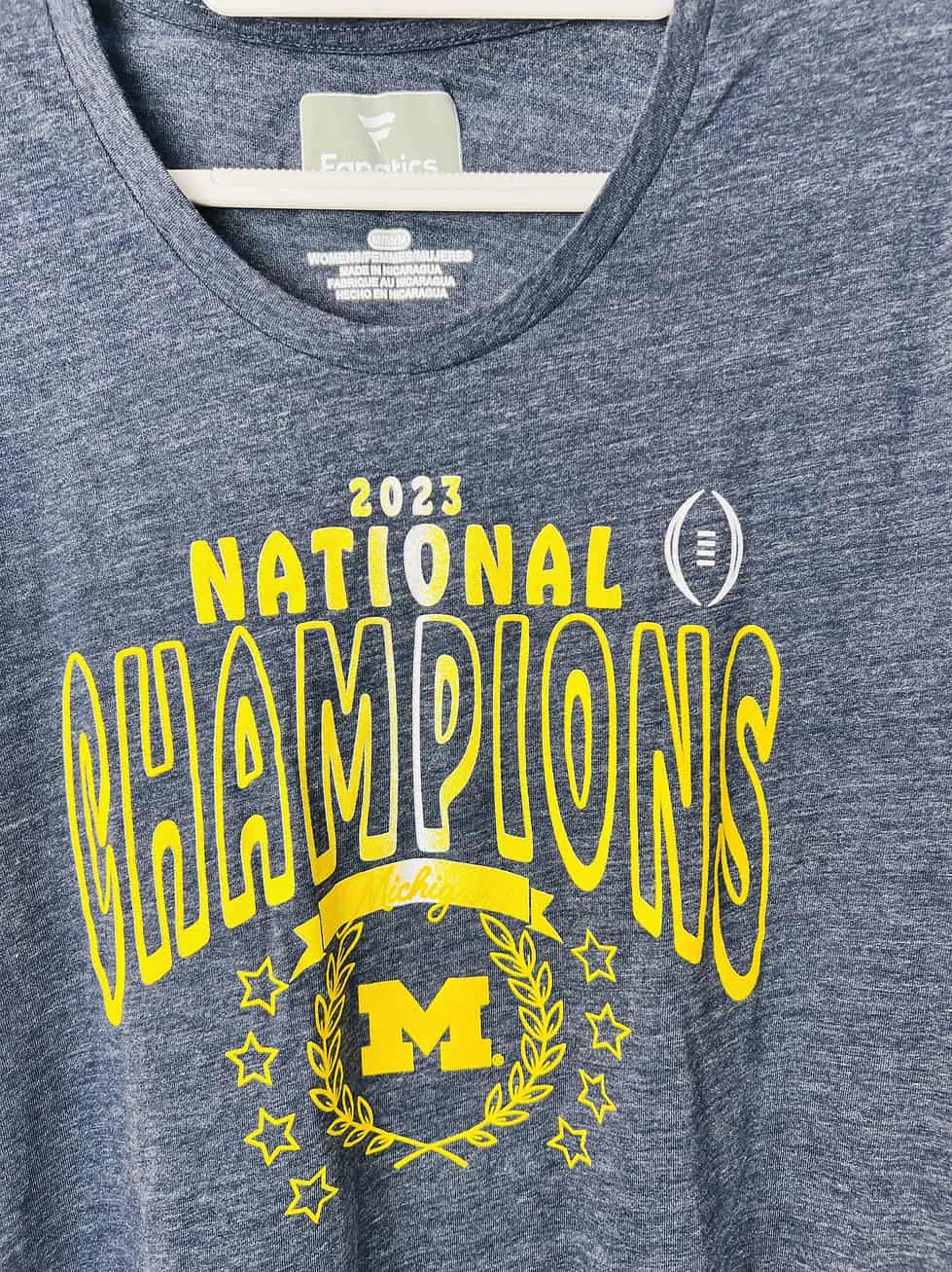 Close-up of Maize and Blue championship design on Michigan shirt.