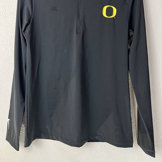 Front view of Nike Oregon Ducks Dri-FIT 1/4 zip polo in black.