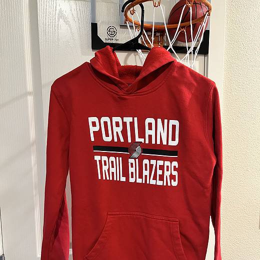 Front view of a red NBA Official Portland Trail Blazers youth hoodie with kangaroo pocket.