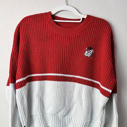 Front view of red and white UGA Bulldogs knit sweater with mascot patch.