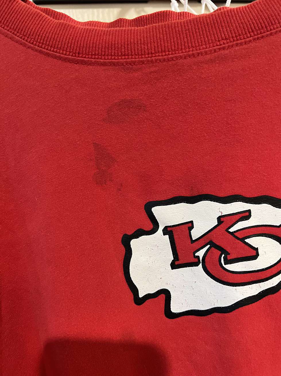 Full view of a red Kansas City Chiefs long-sleeve shirt, featuring the team logo in white and black, size XL.