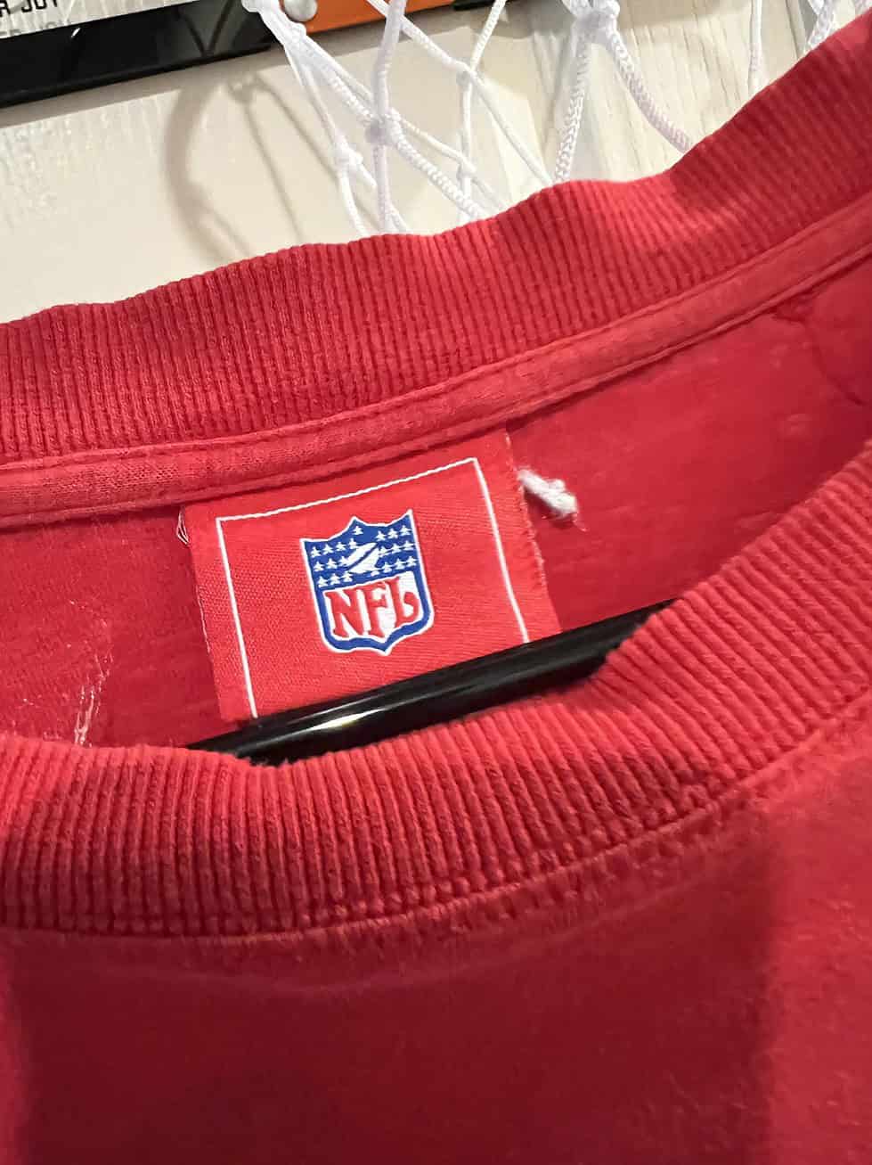 Close-up of NFL Official tag inside a red Kansas City Chiefs long-sleeve shirt, size XL.