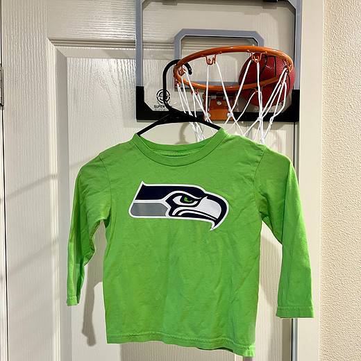Front view of a bright green Seattle Seahawks youth small long-sleeve shirt with the team logo.