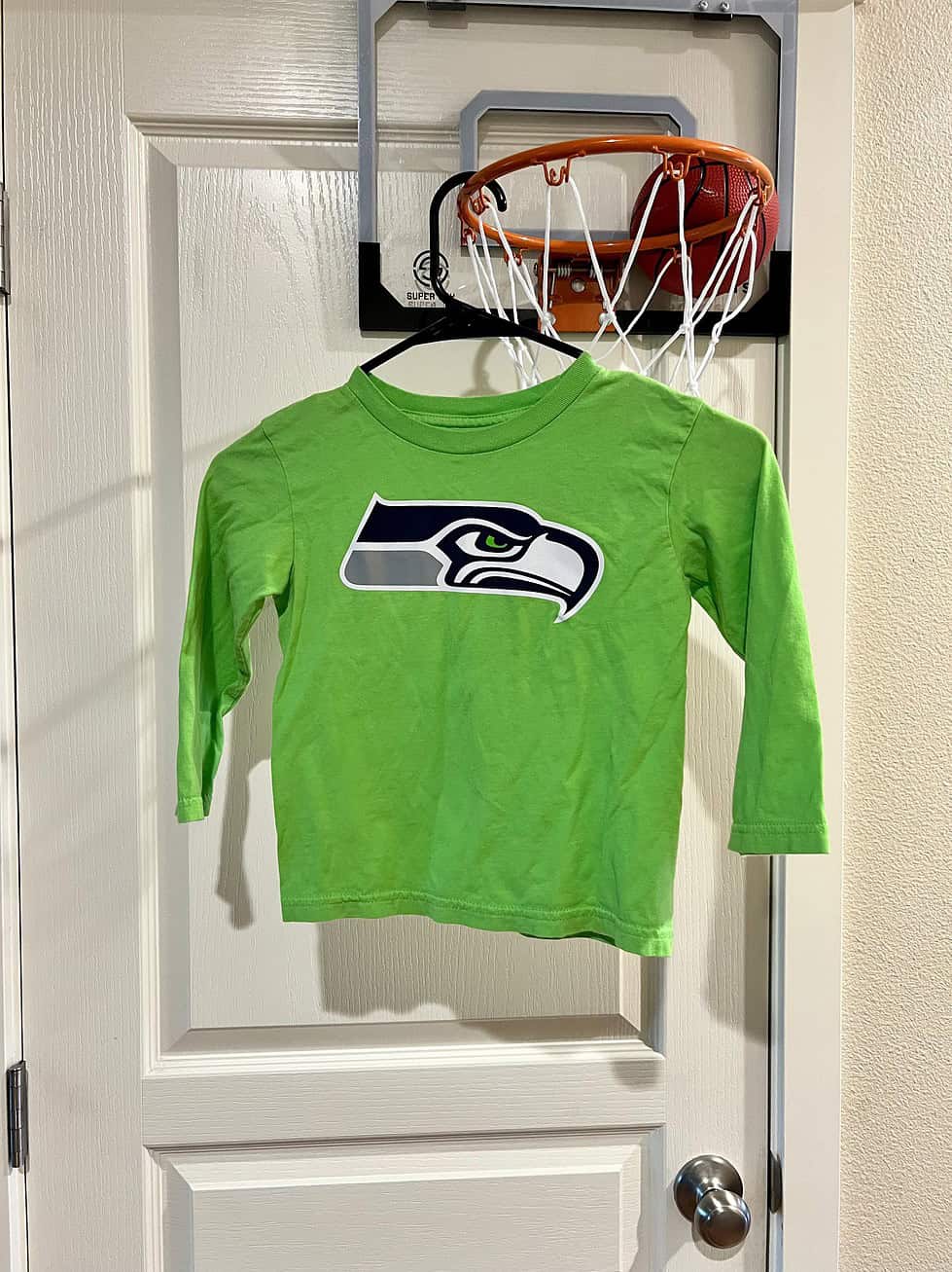 Front view of a bright green Seattle Seahawks youth small long-sleeve shirt with the team logo.