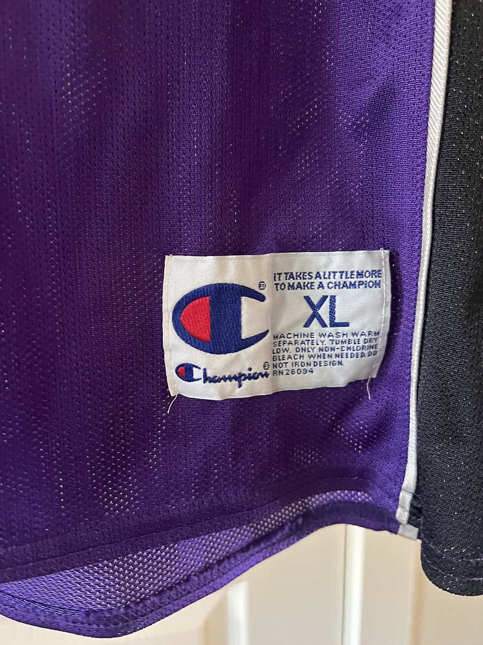 Close-up of Champion XL tag on Sacramento Monarchs purple jersey.