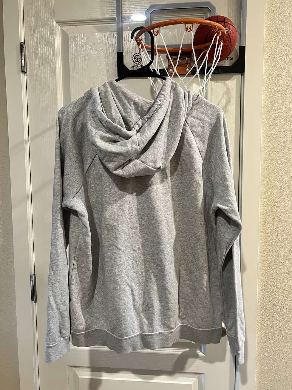 Back view of a gray Nike "Phil Knight Legacy" pullover hoodie.