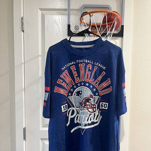 Full front view of a New England Patriots 2XL T-shirt, featuring retro stripes on the sleeves and throwback design.