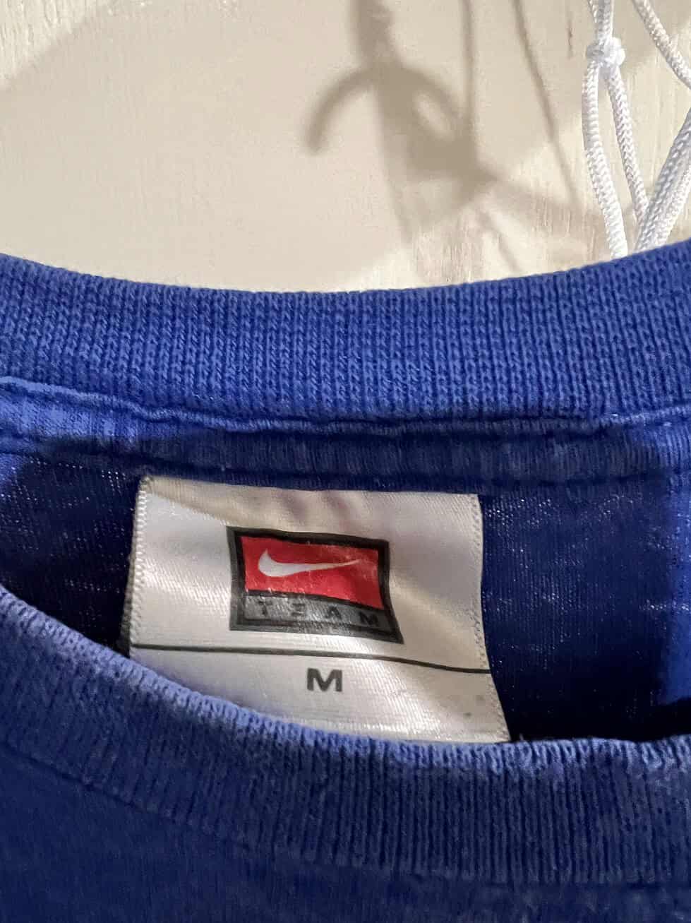 Label inside the collar showing Nike and size "M" on a Kansas City Royals T-shirt.