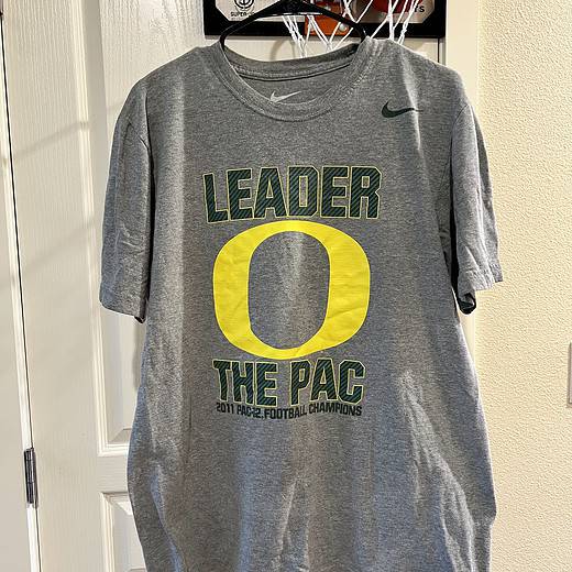 Front view of a gray Nike T-shirt featuring "Leader O The Pac" and Oregon Ducks 2011 PAC-12 Championship graphics.