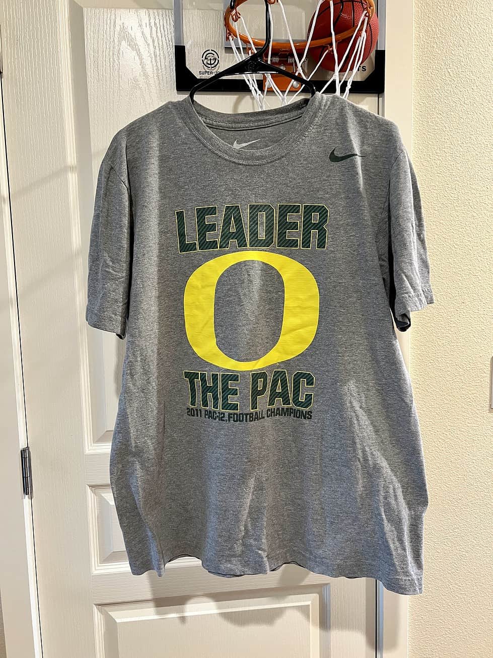 Front view of a gray Nike T-shirt featuring "Leader O The Pac" and Oregon Ducks 2011 PAC-12 Championship graphics.