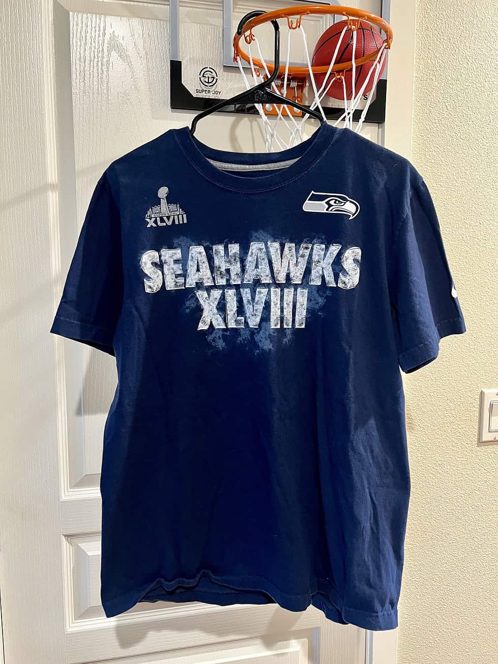Front view of a navy blue Nike T-shirt with “Seahawks XLVIII” graphic and Super Bowl logo.