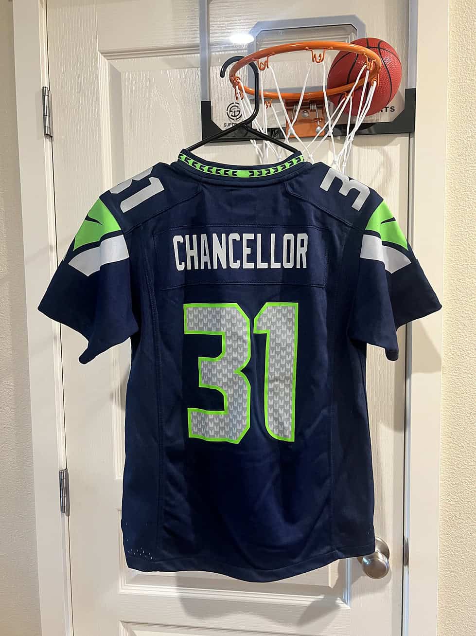 Back view of a Seattle Seahawks Kam Chancellor #31 youth jersey in navy blue with green and gray accents.