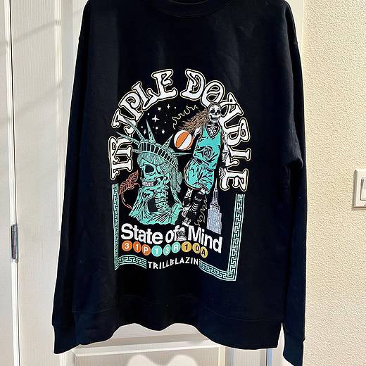 Front view of the "Triple Double" design celebrating Sabrina Ionescu and the 2024 WNBA Champions, featuring NYC-inspired elements on a black Trillblazin sweatshirt.
