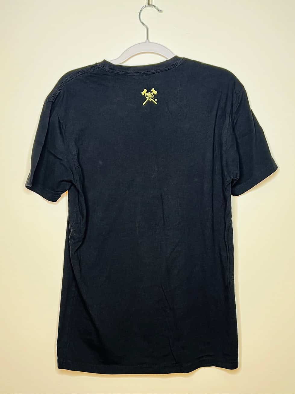 Back of t-shirt with two crossed axes near neck