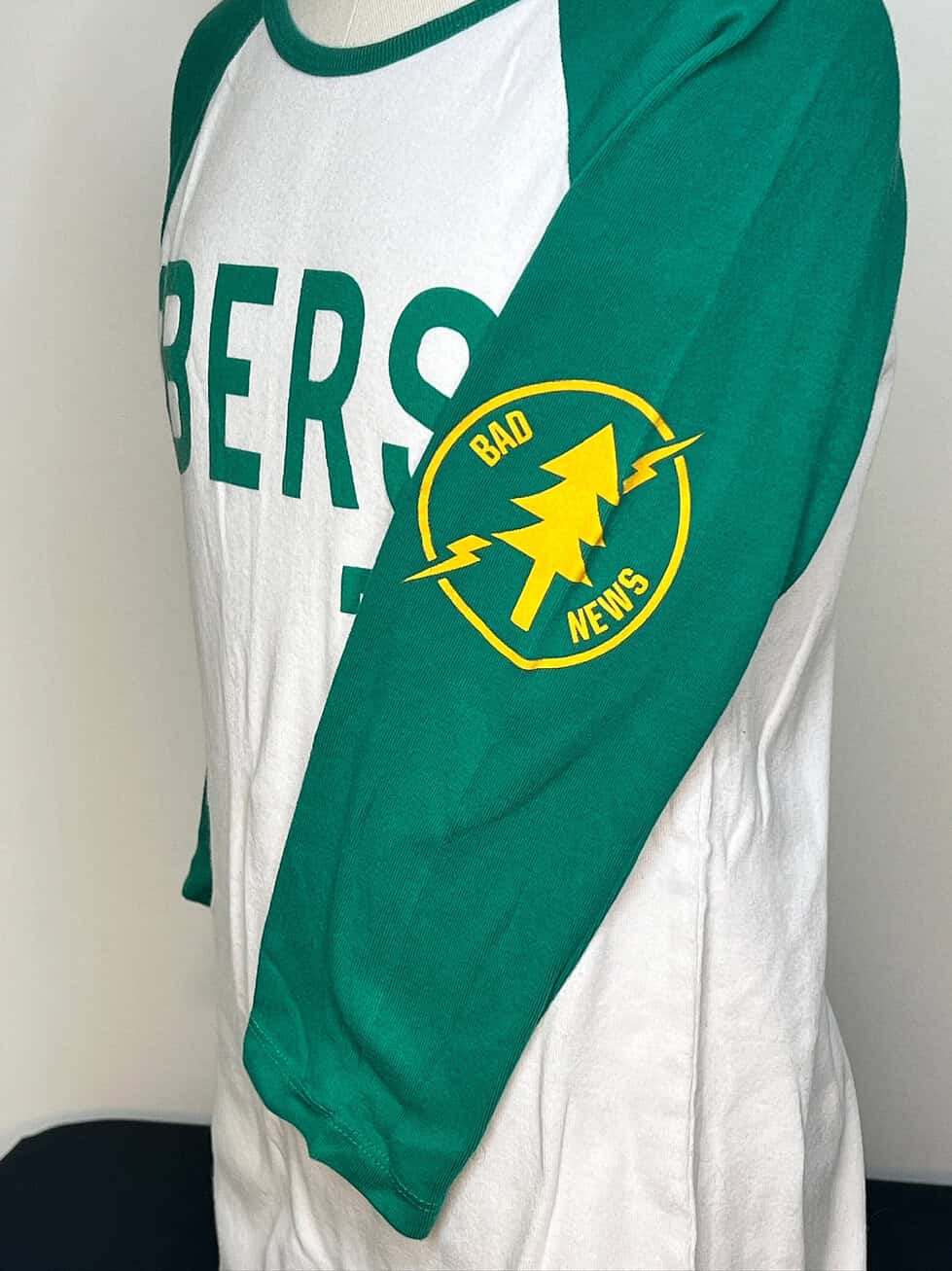 Side view showing “Bad News” logo on left sleeve