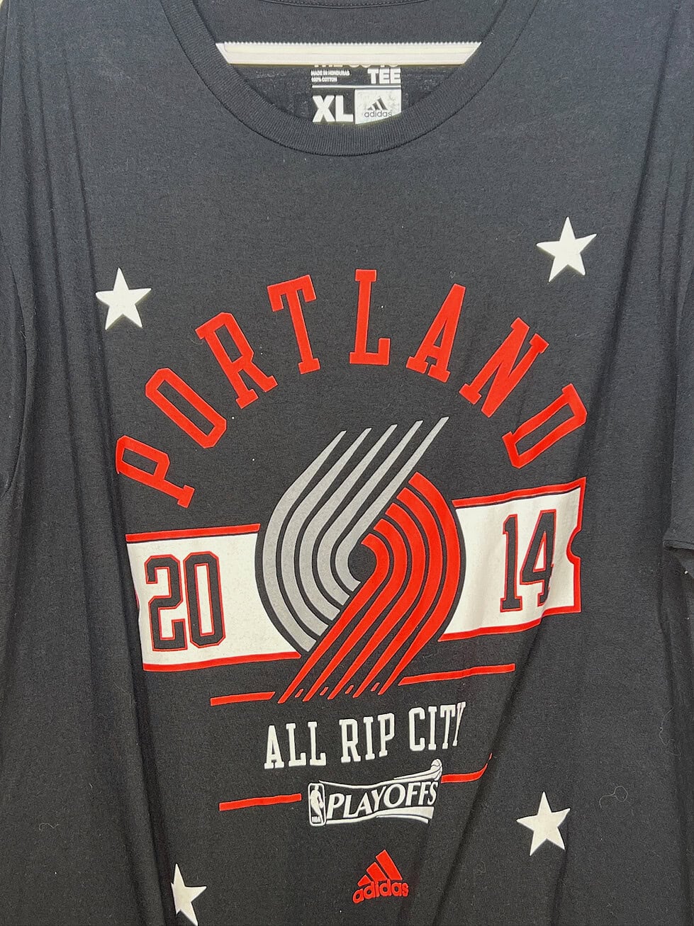 Close-up of Adidas tag on Portland Trail Blazers Playoffs shirt, size XL