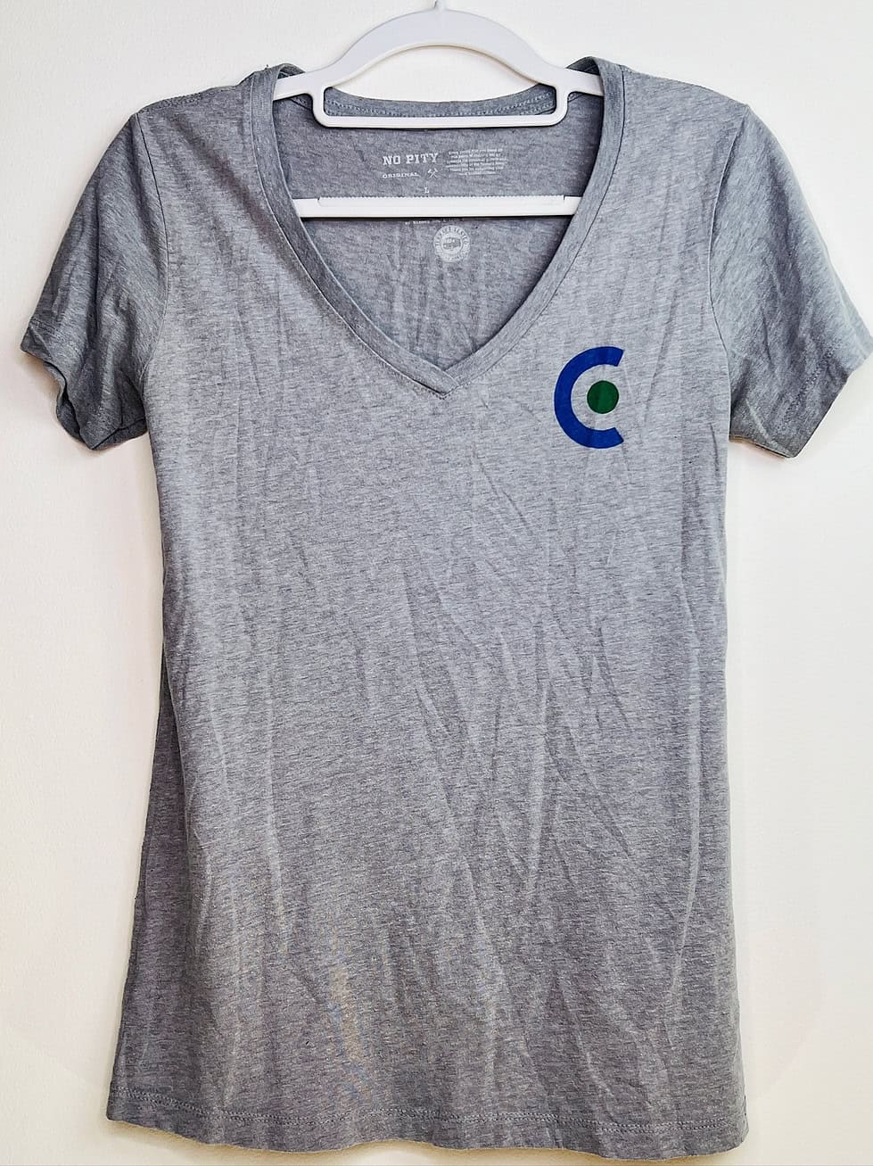 Front of No Pity Originals Cascadia v-neck t-shirt with small ‘C’ logo