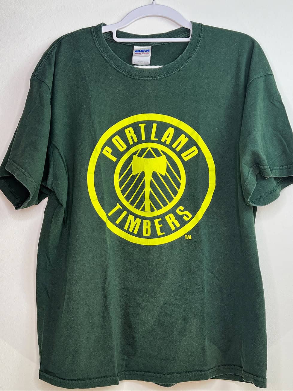 Front view of Portland Timbers green t-shirt with large axe crest graphic
