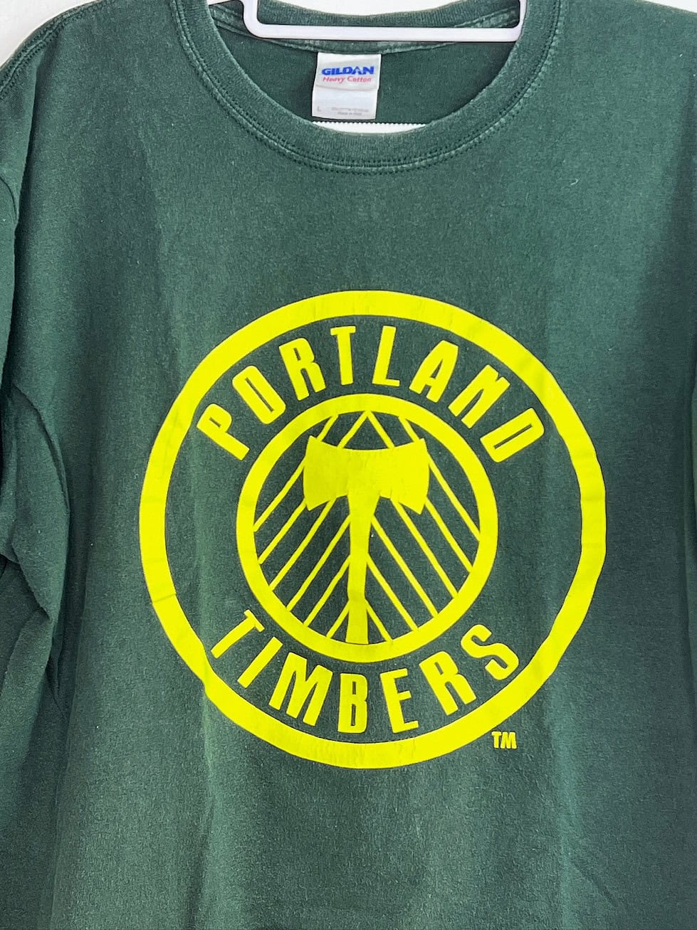 Close-up of Timbers crest on green tee