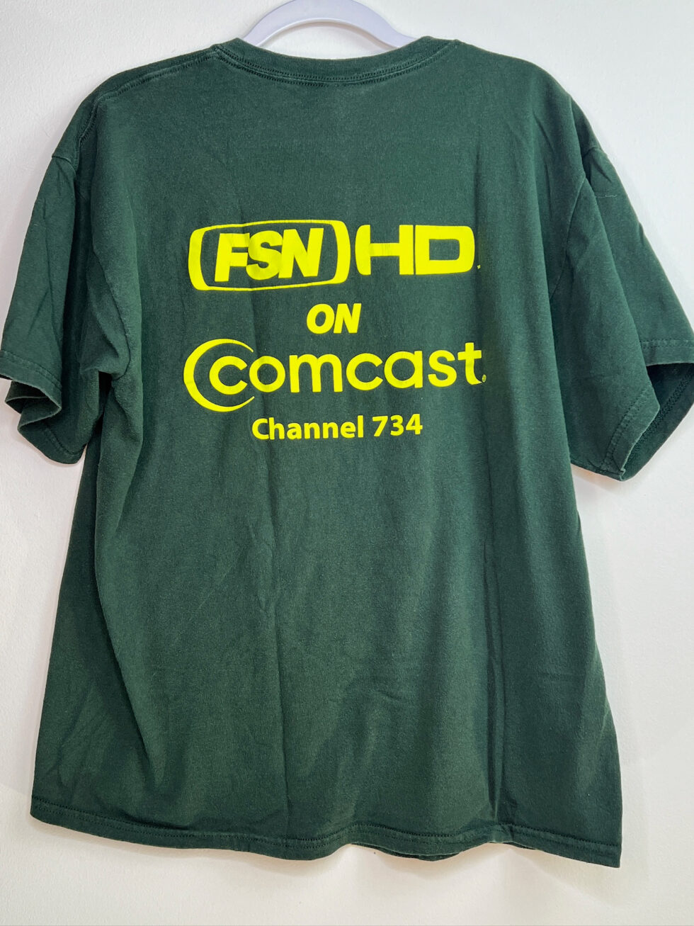 Back view of t-shirt showing Comcast logo