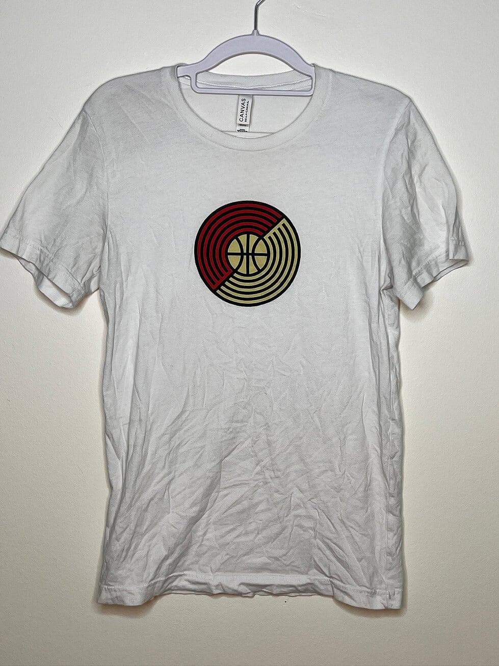 White t-shirt displaying round version of logo
