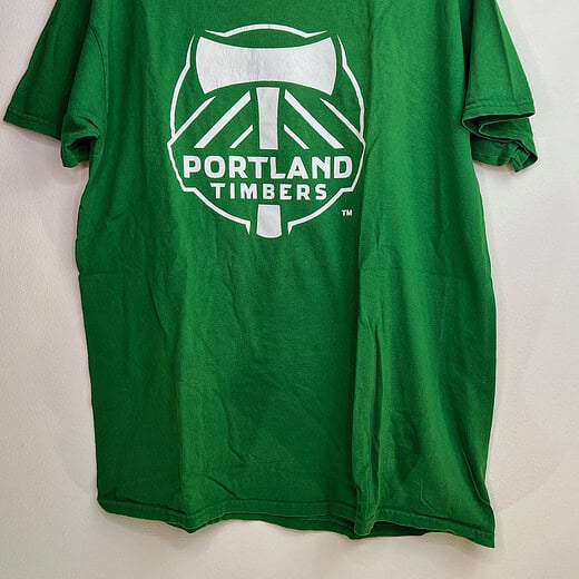 Front view of Portland Timbers green t-shirt with large axe crest graphic