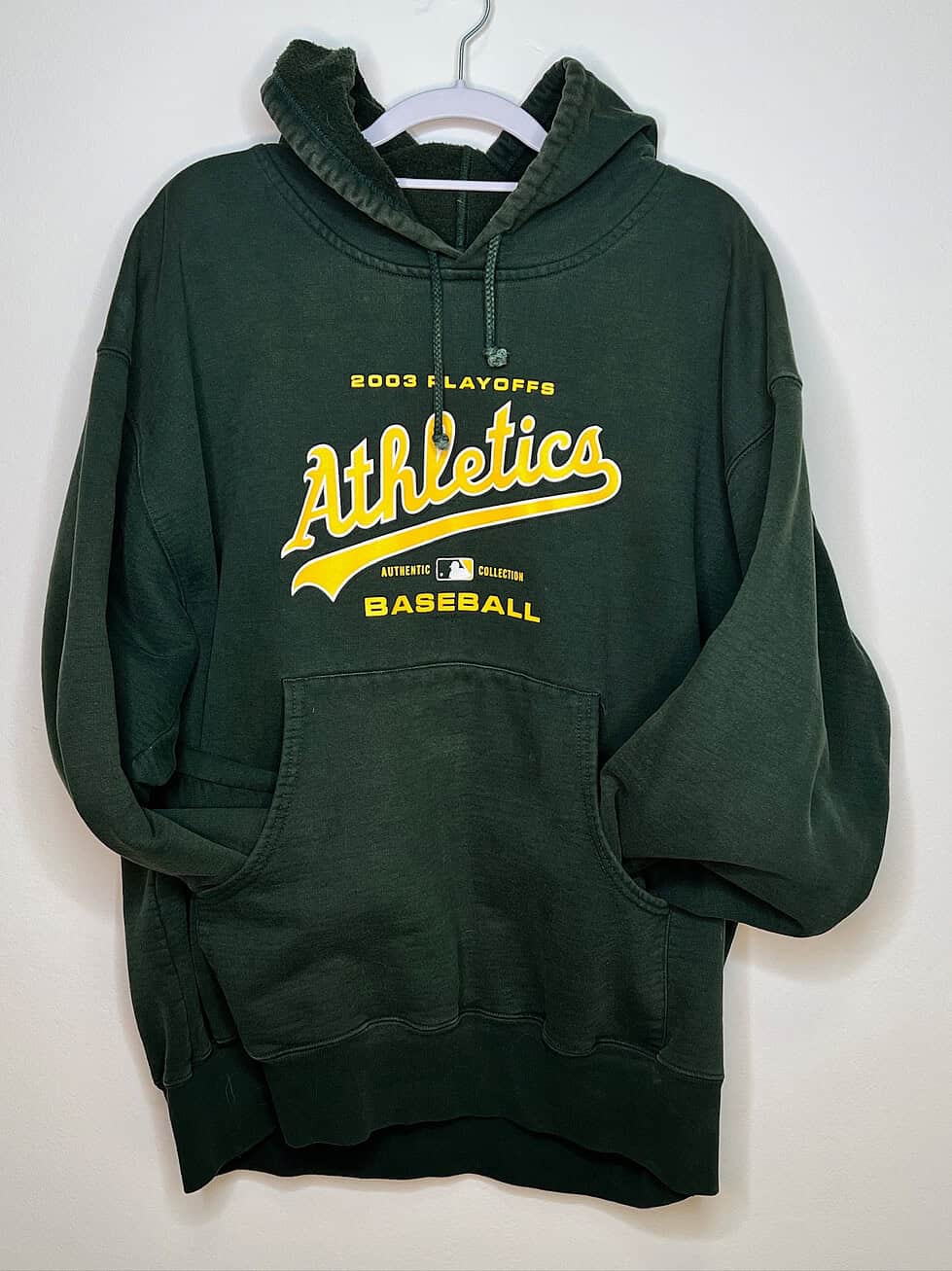 Front of hoodie. Dark green with yellow text
