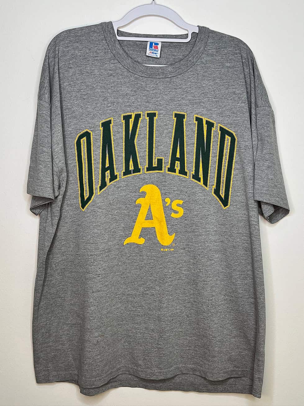 Front of t-shirt. Grey with yellow and green logo & text