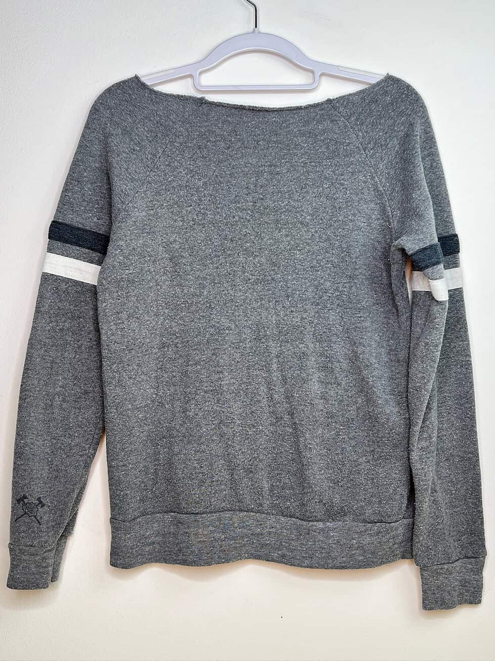 Back of sweater with striped sleeves, size view
