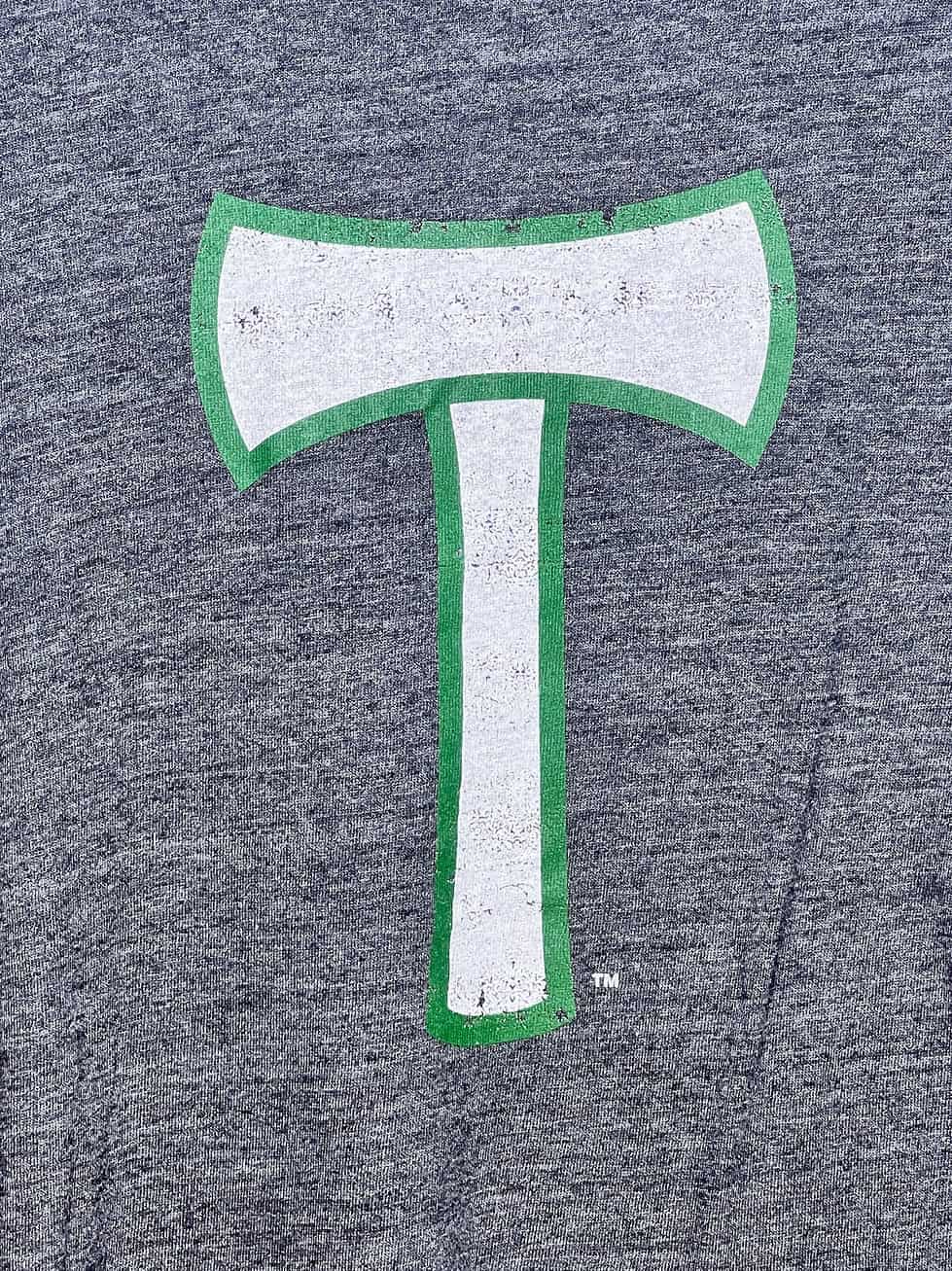 Close-up of green-outlined white t-axe logo