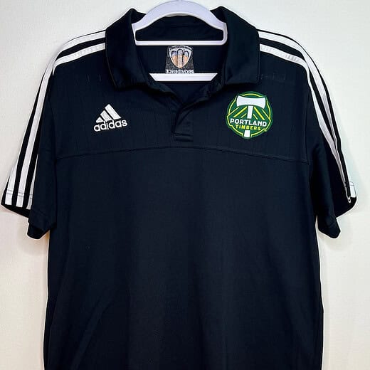 Front view of black Adidas Portland Timbers polo