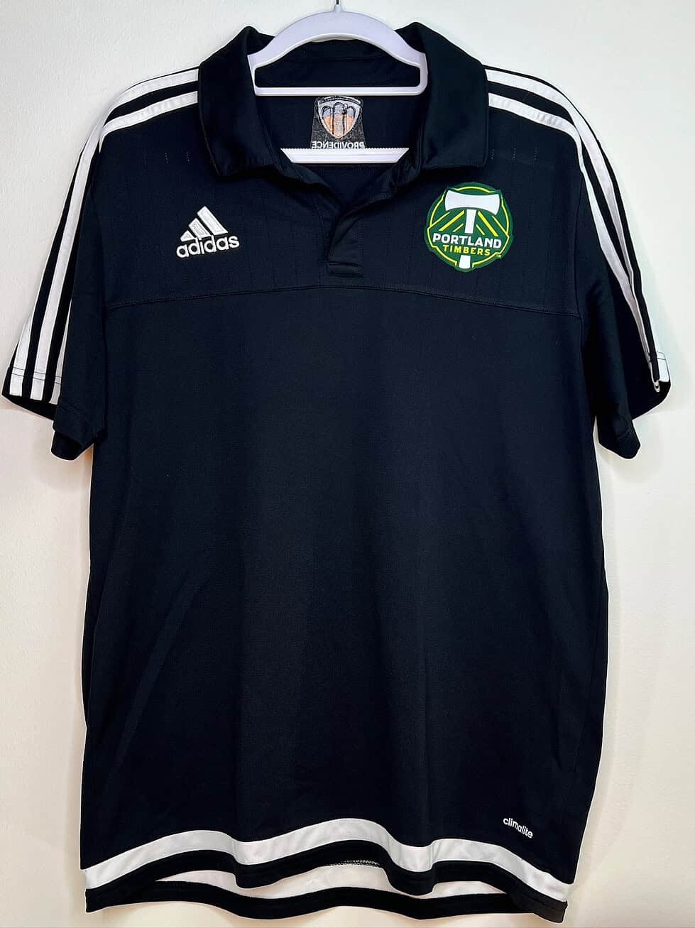 Front view of black Adidas Portland Timbers polo