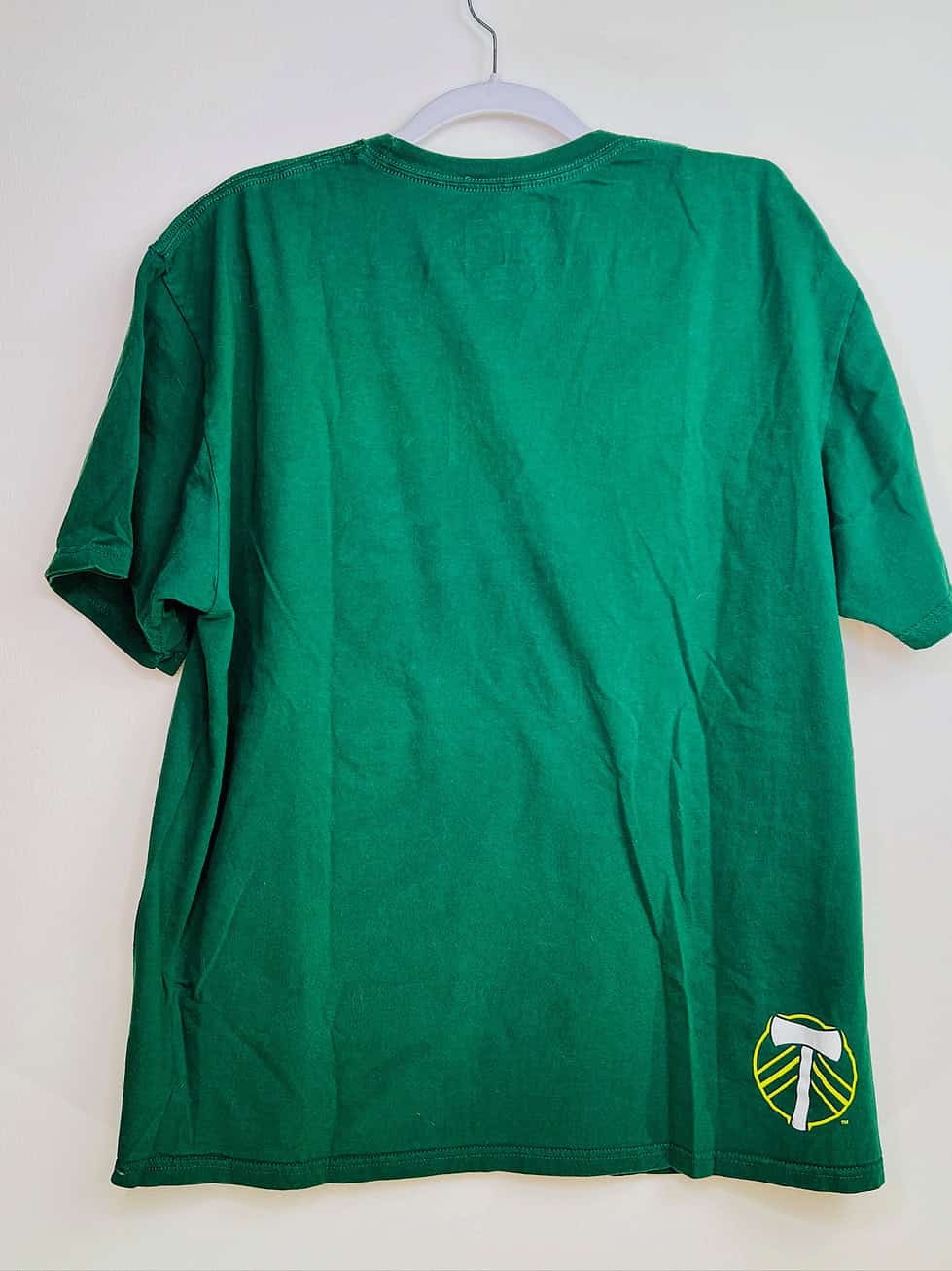 Back view of green Timbers anniversary tee