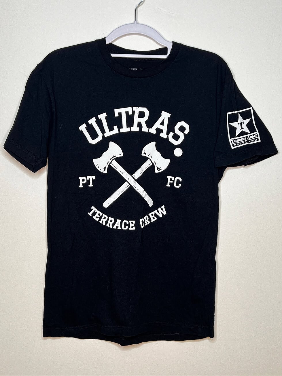 Front of t-shirt. Black with white Ultras Terrace Crew logo and two crossed axes. Star logo on sleeve