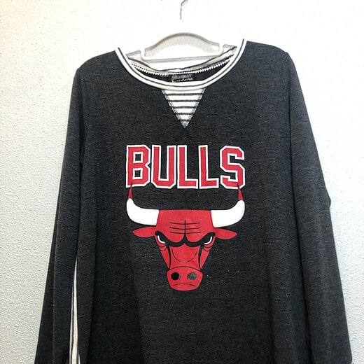 Full front view of Chicago Bulls Gameday Couture tunic showing bold logo and stylish hem