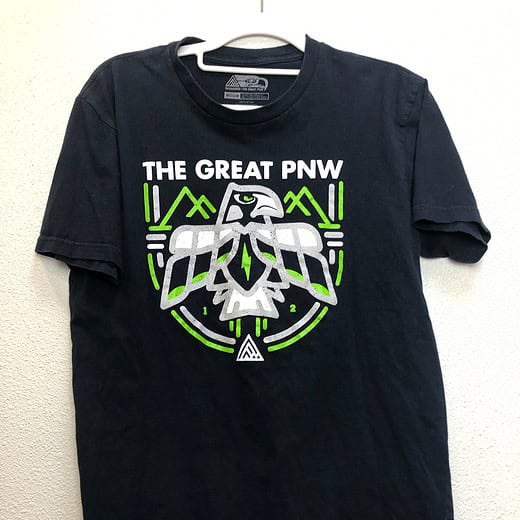 Front view of “The Great PNW” Seattle Seahawks tee in navy with green and white indigenous hawk graphic.