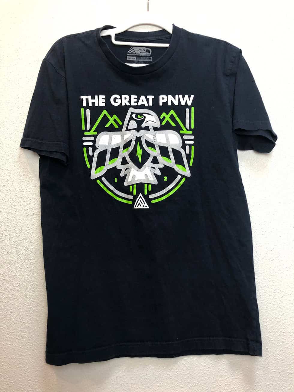 Front view of “The Great PNW” Seattle Seahawks tee in navy with green and white indigenous hawk graphic.