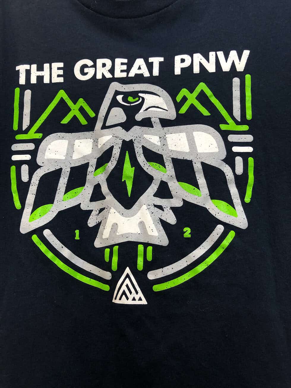 Close-up of “The Great PNW” and hawk design on the front of the shirt