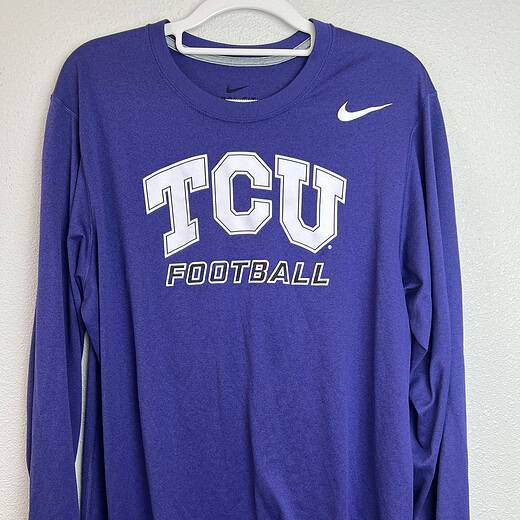 Purple TCU Nike Dri-FIT long-sleeve tee with "TCU Football" text in white, crewneck design, size medium.