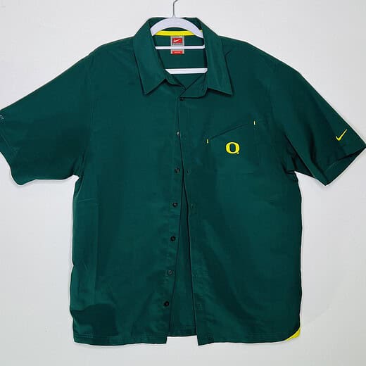 Front view of Oregon Ducks team-issued Nike button-up shirt with yellow 'O' logo.