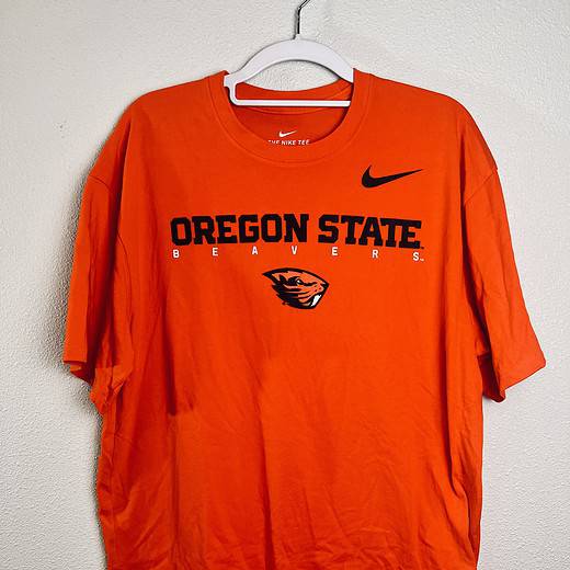 Oregon State Nike Dri-FIT orange t-shirt with Beavers logo on hanger.