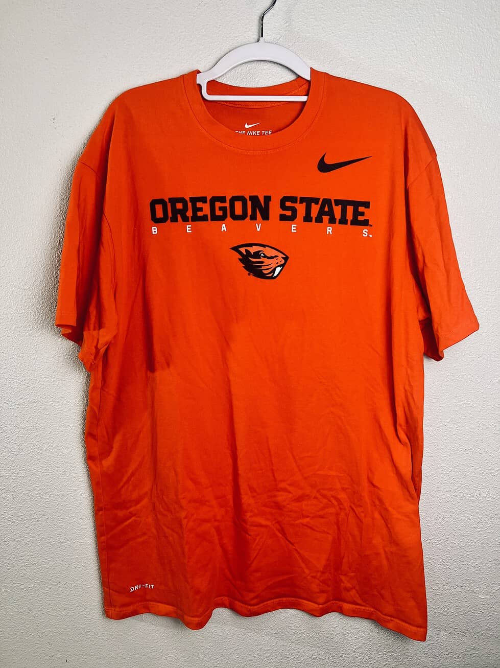 Oregon State Nike Dri-FIT orange t-shirt with Beavers logo on hanger.