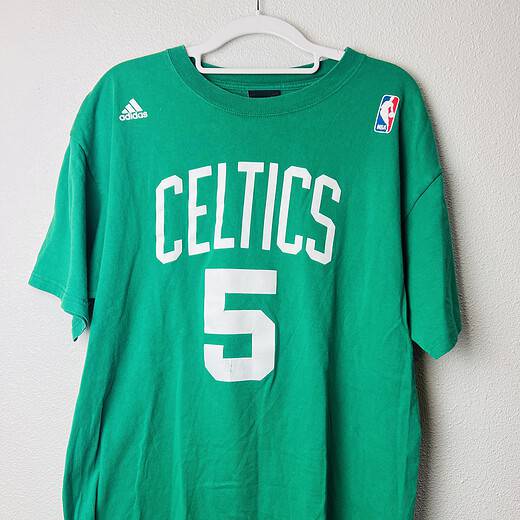 Green Adidas Kevin Garnett Boston Celtics t-shirt with “Celtics” and #5 on the front, and “Garnett” with #5 on the back, size medium.