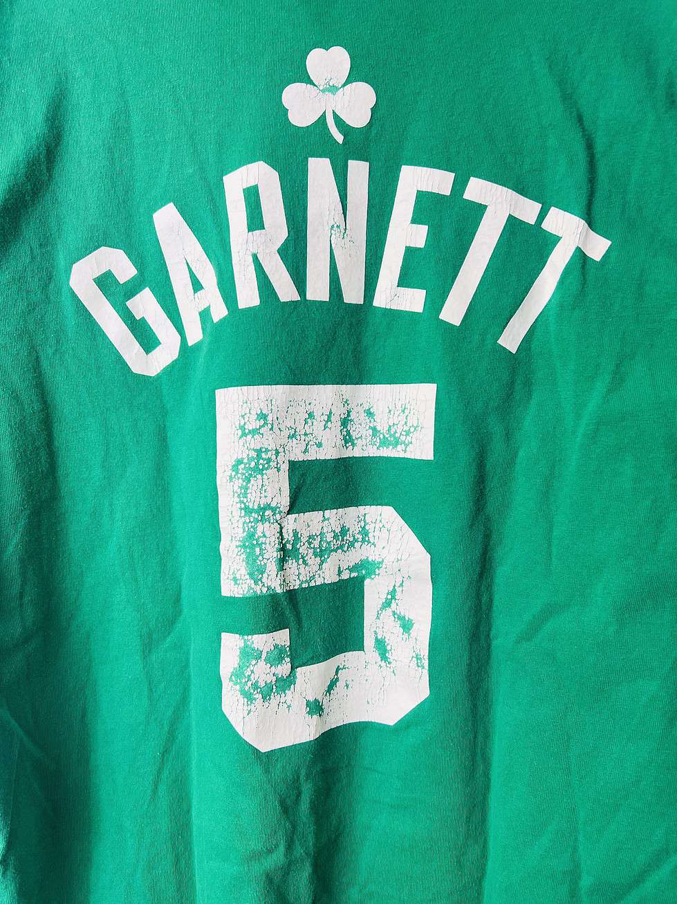 Green Adidas Kevin Garnett Boston Celtics t-shirt with “Celtics” and #5 on the front, and “Garnett” with #5 on the back, size medium.
