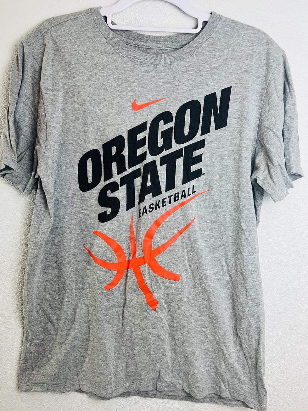 Front of Oregon State Basketball Nike team-issued gray tee with orange basketball graphic.