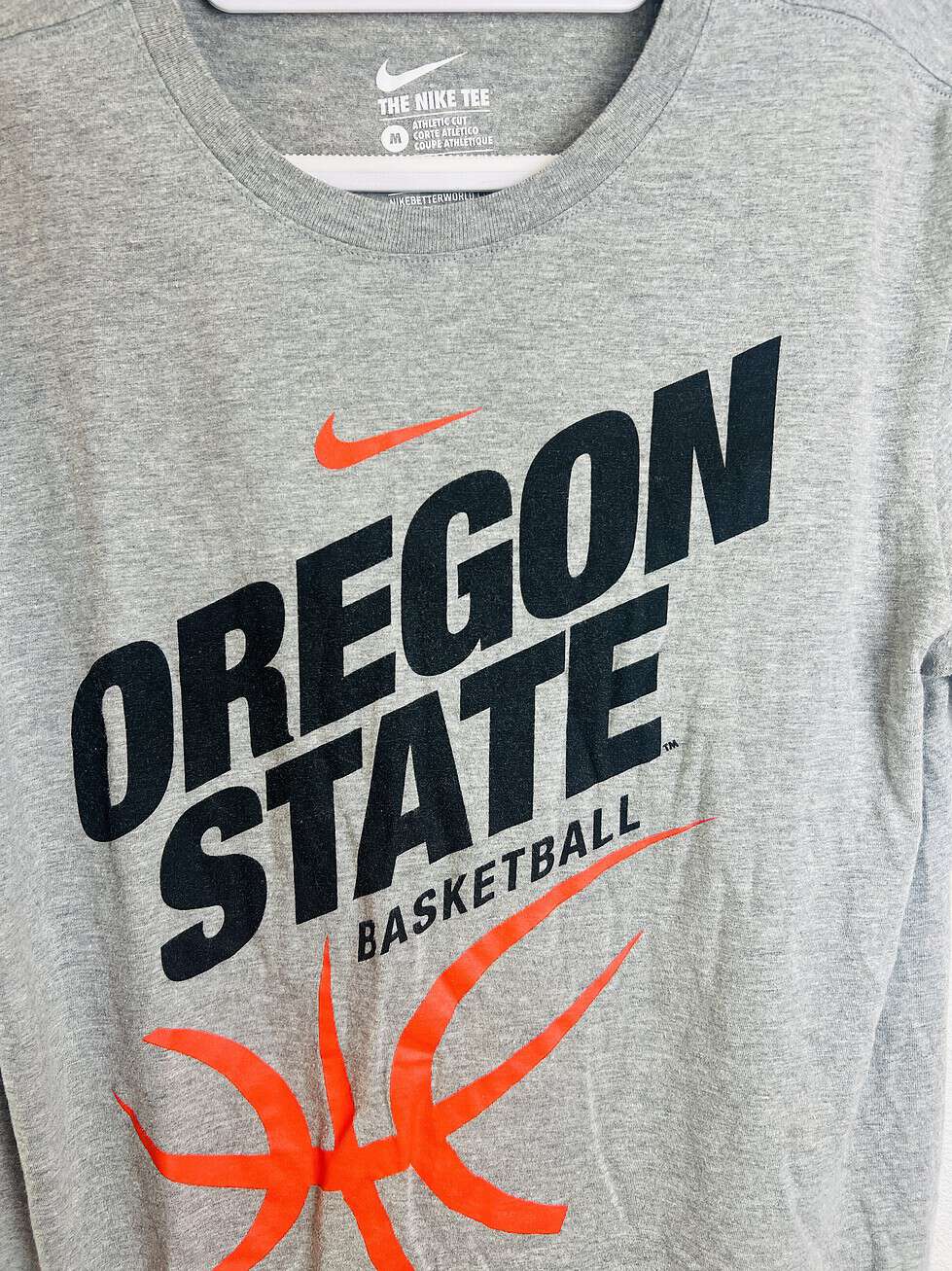 Close-up of Oregon State Basketball design and Nike swoosh on team tee.